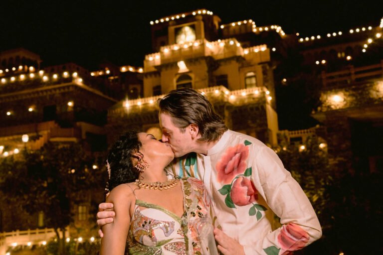 A Couple kissing again Neemrana Fort at their wedding.